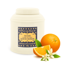 Boîte de thé noir orange et fleur d'oranger Le Secret de la Lance - orange fleur d'oranger posées à côté de la boîte
