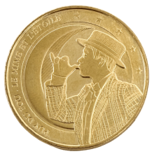 Jeton touristique Puy du Fou Le Mime et l'Étoile – face dorée avec le mime sur fond de lune et étoiles, frappé par la Monnaie de Paris