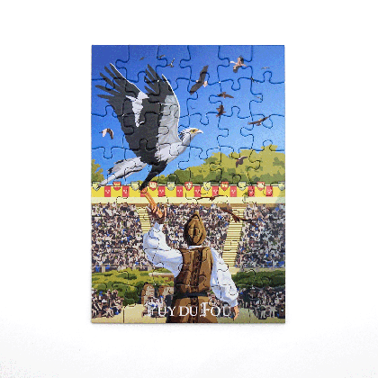 Puzzle reconstitué du Bal des Oiseaux Fantômes : grand condor noir et blanc en vol au-dessus du fauconnier et des rapaces dans le ciel bleu