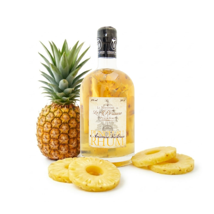 Punch au rhum Ananas Victoria Puy du Fou 70cl entouré d'un ananas Victoria frais et de rondelles d'ananas