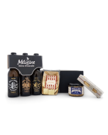 Produits du coffret gourmand salé posés devant la boîte noire : tripack de bières artisanales Mélusine, biscuits préfou, terrine de canard et couteau alpage.