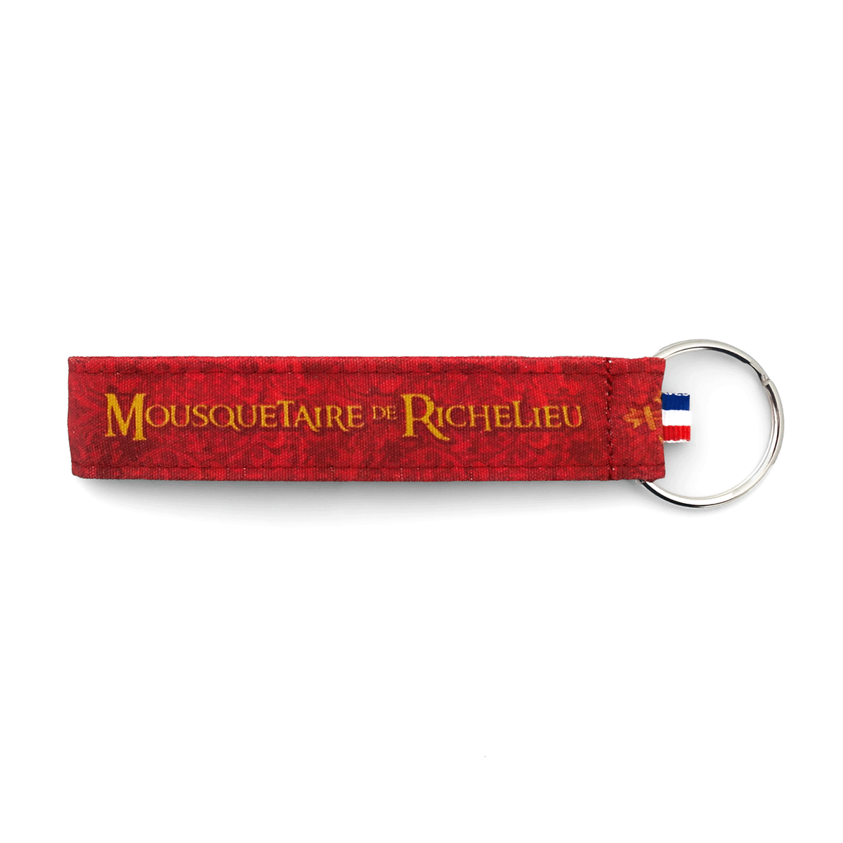 Porte-clés tissu Puy du Fou Mousquetaire de Richelieu – détail de l'inscription dorée sur fond rouge cardinal