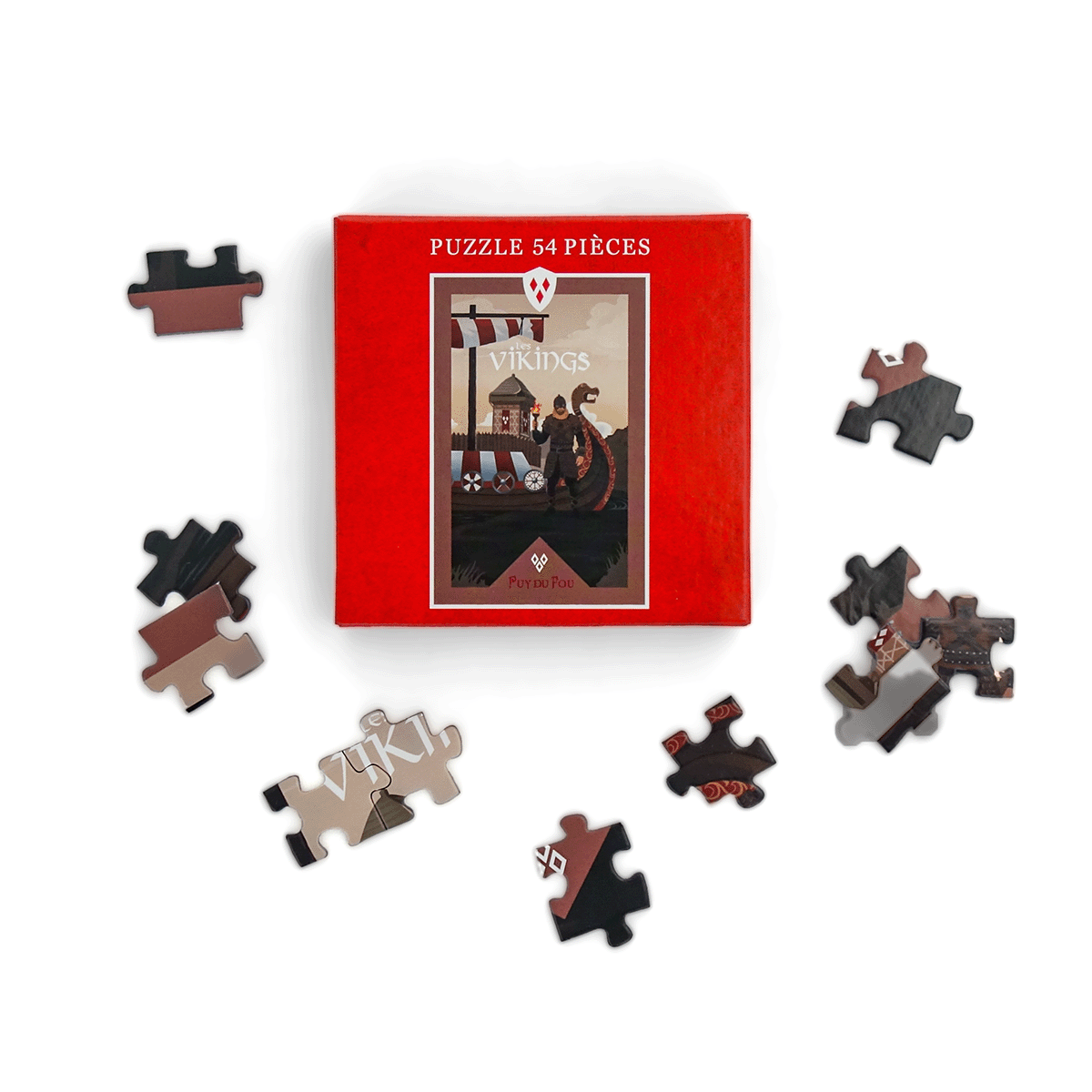 Puzzle 54 pièces Les Vikings Puy du Fou – pièces du puzzle éparpillées autour de la boîte rouge, illustration du spectacle nordique
